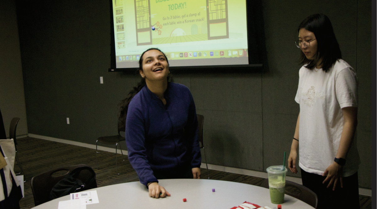 Meera Vyas, a computer science student, keeps her eyes trained on a small blue bead while playing gonggi, a Korean playground game at the Global Connections meetup on Monday.